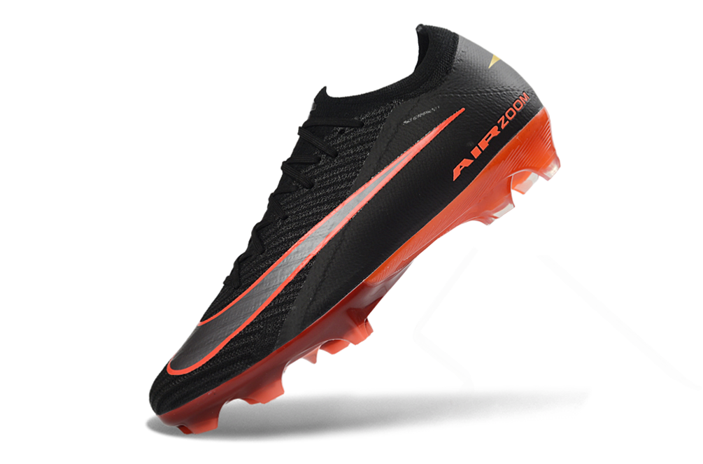 Close-up of Nike Air Zoom Mercurial Vapor XVI Elite FG soccer cleats, black and inferno color scheme
